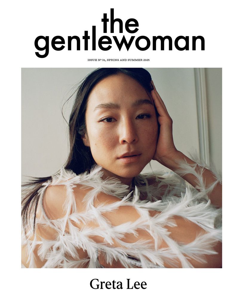 Greta Lee graces The Gentlewoman cover, Issue N° 31, Spring and Summer 2025, sporting white feathered attire and a serene pose.