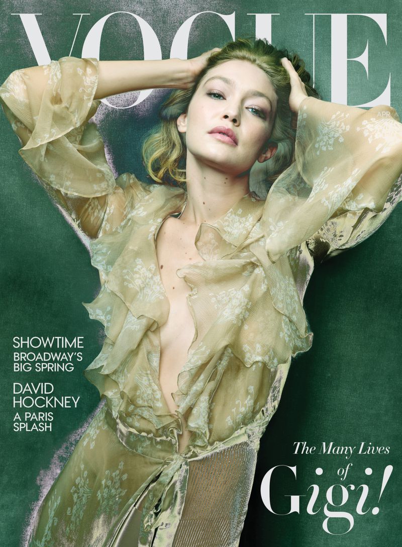 Vogue cover featuring Gigi Hadid in a sheer floral top, with Vogue masthead at the top and text about Broadway and David Hockney.