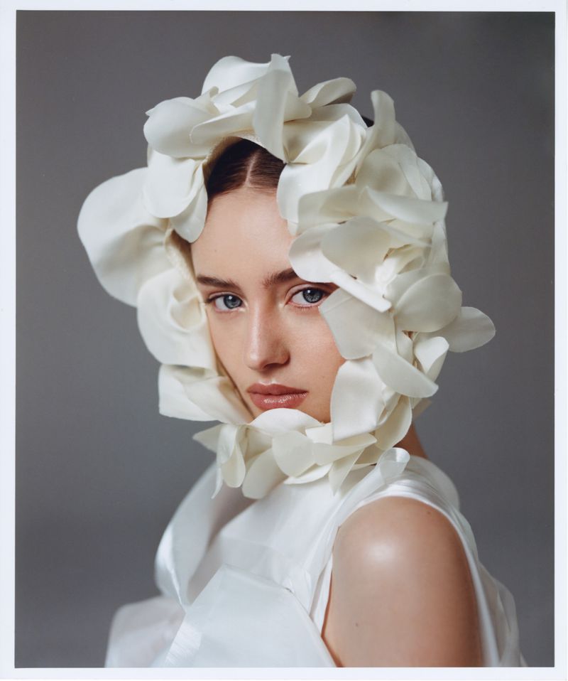 Model Leni Klum wearing a white floral headpiece and matching white top for Glamour Germany March 2025 cover shoot