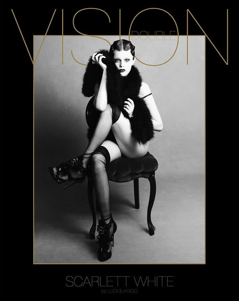 A woman in lingerie sits on a chair with black-and-white filter. She wears heels and a fur stole, while magazine text borders the shot.
