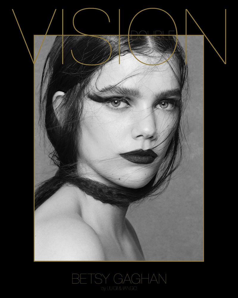 Portrait of a woman with dark hair and lipstick against a black and grey background with gold text overlaying her face and shoulders.
