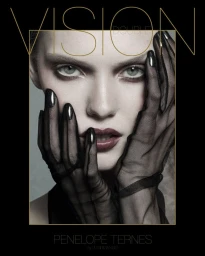 Close-up portrait of a model with hands framing the face, wearing sheer black gloves and dark nail polish for Double Vision A/W 2025.