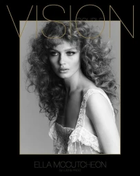 Monochrome portrait of a woman with voluminous curly hair wearing a white lace dress against a grey background