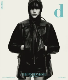 Model wearing a black hooded leather jacket and dark shorts against a seamless white background for D Repubblica magazine cover.