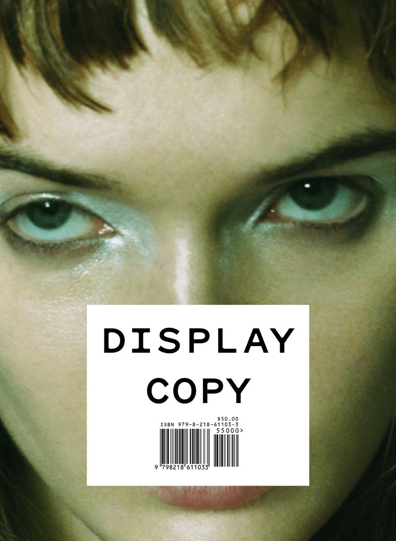 Close-up portrait of a woman's face with her eyes looking directly at the viewer, framed by her hair and featuring text overlay.