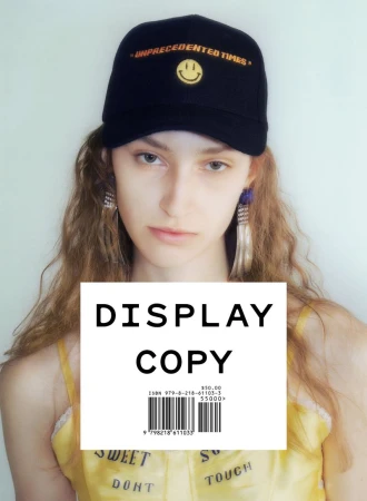 Model wearing a black embroidered cap and yellow top against a light background for Display Copy
