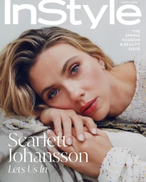 Scarlett Johansson resting her head on her hands for the InStyle U.S. March 2025 magazine cover portrait.