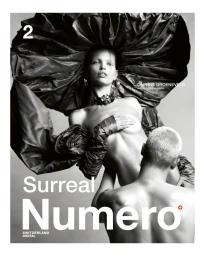 Black and white portrait of model Daphne Groeneveld wearing a large sculptural ruffled headpiece, supported by a man.