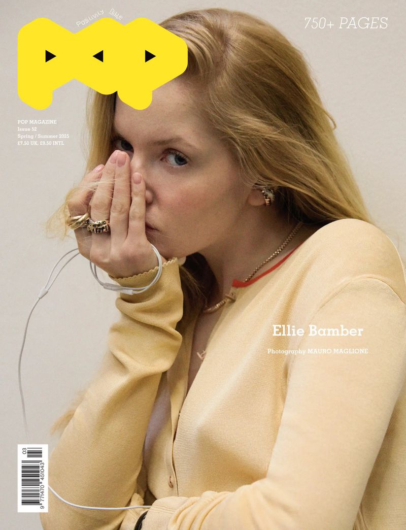 POP magazine cover featuring a blonde woman with her hands near her face, wearing a yellow cardigan against a light background.