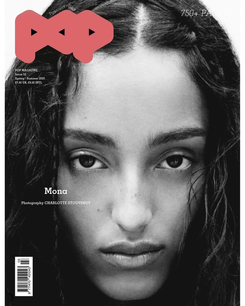 Close-up monochrome portrait of a model with dark wavy hair and intense gaze featured on Pop Magazine #52 cover