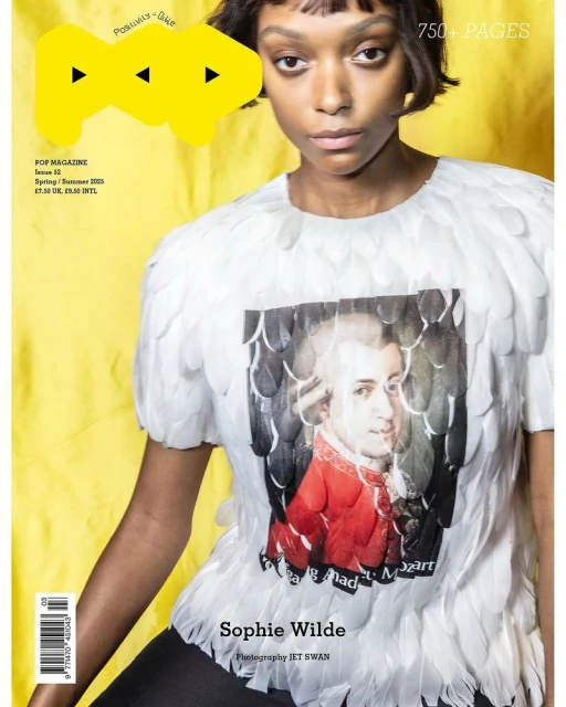 Magazine cover featuring an adult female with a Mozart graphic tee, against a bright yellow backdrop with magazine branding and text.