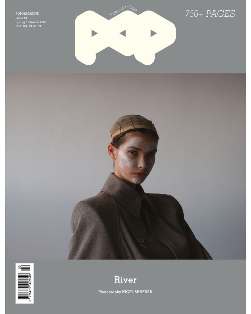 Magazine cover featuring a model with white face paint wearing a wool coat and head covering, with the POP magazine logo at the top.