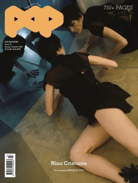 Magazine cover featuring model Nina Cristante in a black dress lying on the floor and a reflection of another model. 