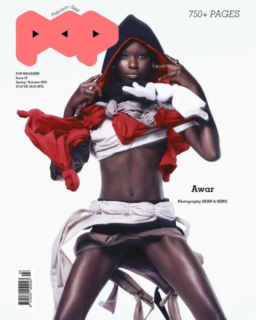 Magazine cover featuring a Black fashion model in layered red and white clothing, hooded, with the word 'POP' and page numbers visible.