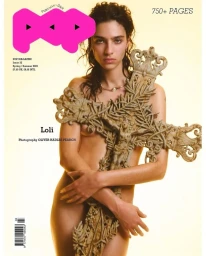 Model Loli Bahia holding a large ornate stone crucifix on a magazine cover for Pop Magazine #52