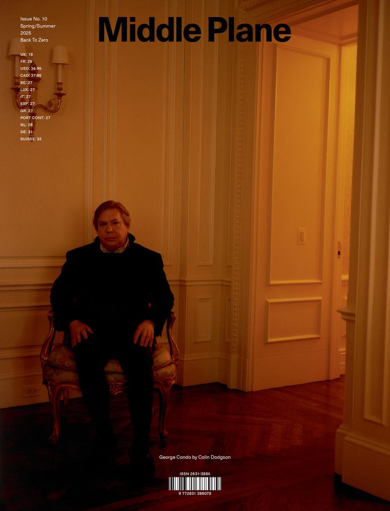 Magazine cover featuring George Condo seated in a formal setting. Warm lighting highlights the architecture and interior design.