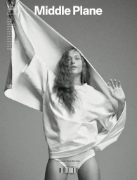 Model wearing a white t-shirt with arms raised, featured on a magazine cover with text