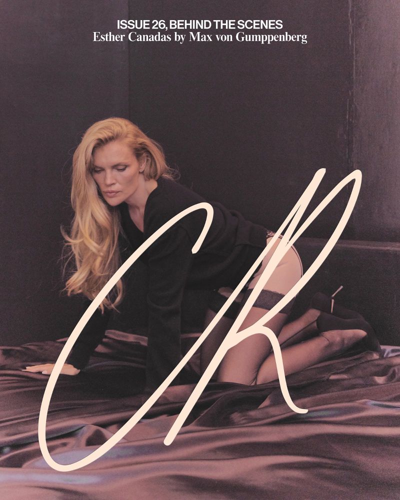 Blonde woman in a black outfit poses on satin sheets, viewed at eye level, with a dark backdrop and an overlaying script font.