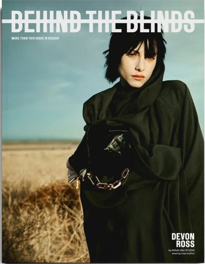 Magazine cover featuring Devon Ross in black hooded dress, against a pale blue and brown landscape background.