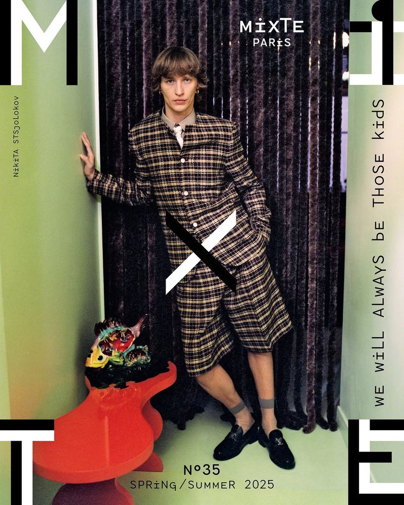 Fashion magazine cover featuring a model in a plaid suit and short. The design includes bold typography and a modern artistic aesthetic.