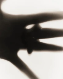 Close-up blurry silhouette of a hand against a bright white background for Ashlyn S25 project