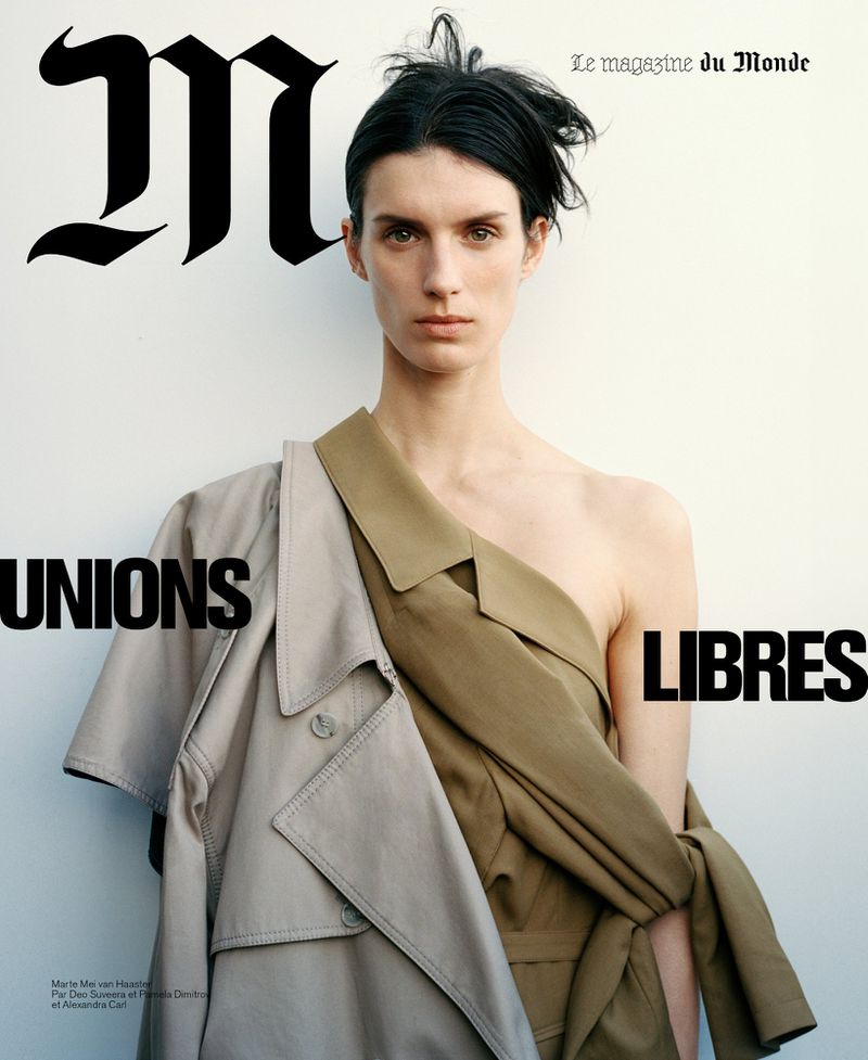 Magazine cover featuring a woman in a draped tan garment and a beige trench coat, posing against a light background with bold text.