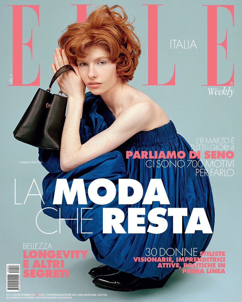 Elle Italia magazine cover featuring a model with red hair, wearing a blue dress and holding a black purse against a blue background.