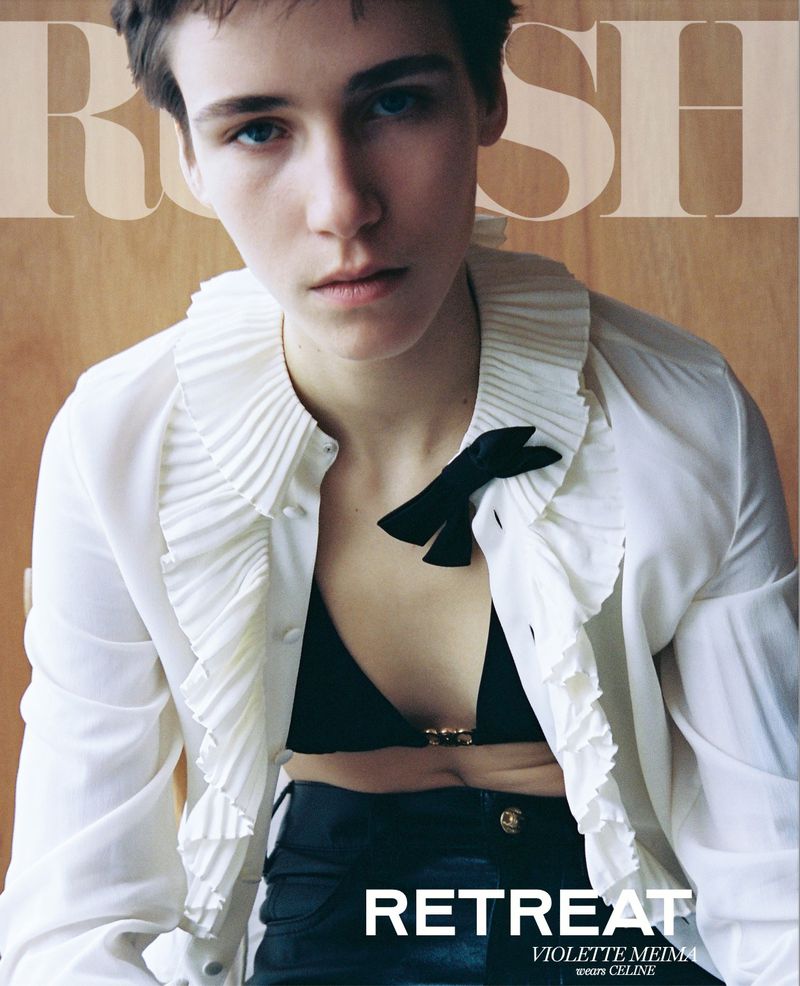 Close-up fashion portrait of a woman with short hair in a white ruffled blouse, a black bow, and black leather pants. Magazine style.