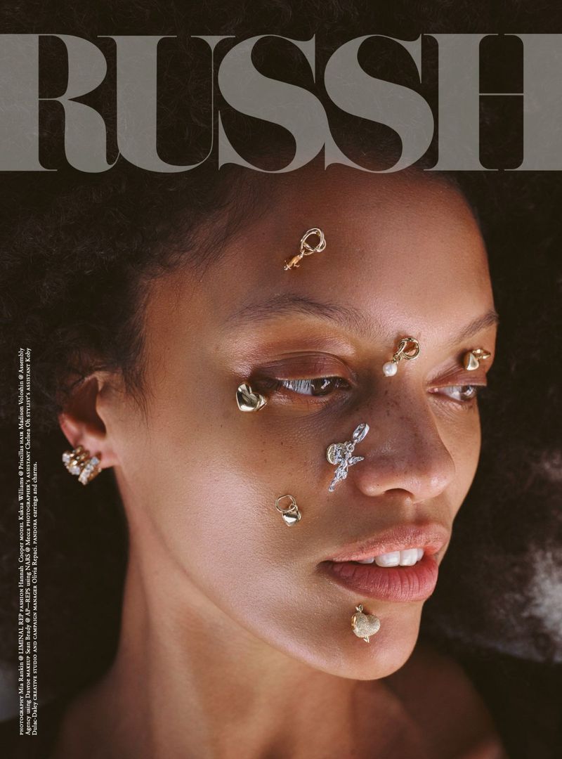 Close-up portrait of a model with delicate gold and silver charms affixed to her face for Russh March 2025.