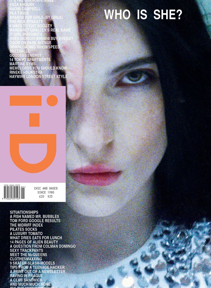 Magazine cover featuring a close-up of a woman's face with dark hair and pale skin, partially obscured by her hand.