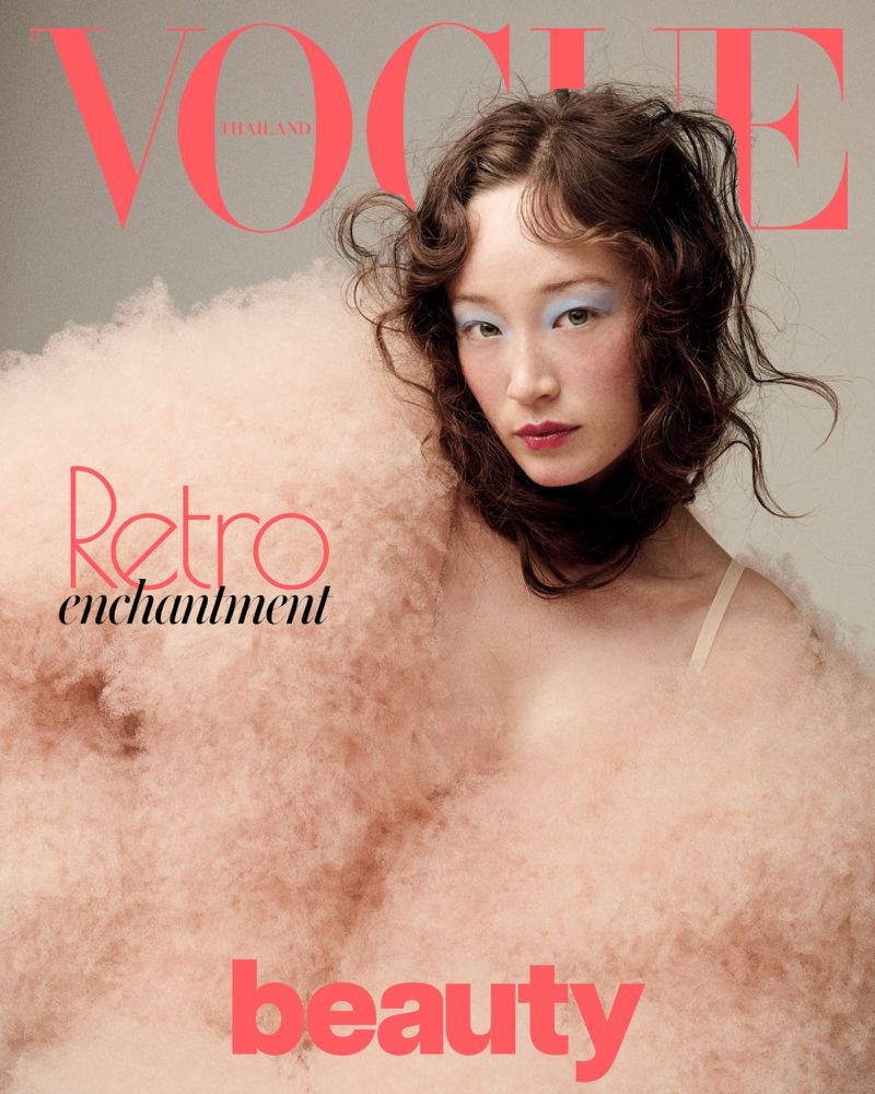 Vogue Thailand cover featuring a young Asian woman with dramatic blue eye makeup, framed by a soft, fluffy pink shawl-like garment.