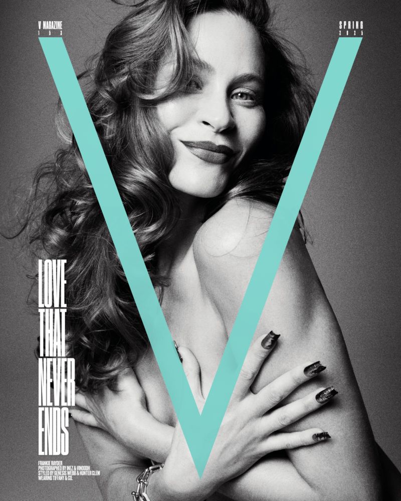 Black-and-white fashion shot of a woman with long wavy hair, posing with her arms crossed on the cover of 'V Magazine'.