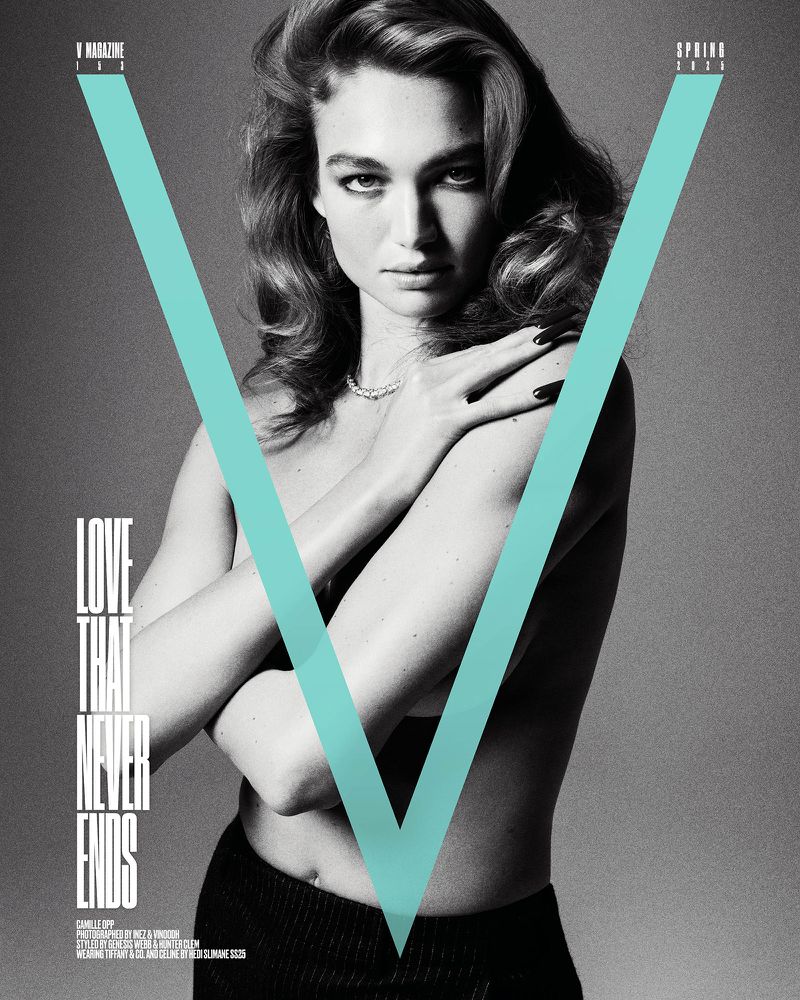 V Magazine cover featuring a fair-skinned woman with wavy brown hair, wearing a necklace, black bottoms, and teal V graphic overlay.