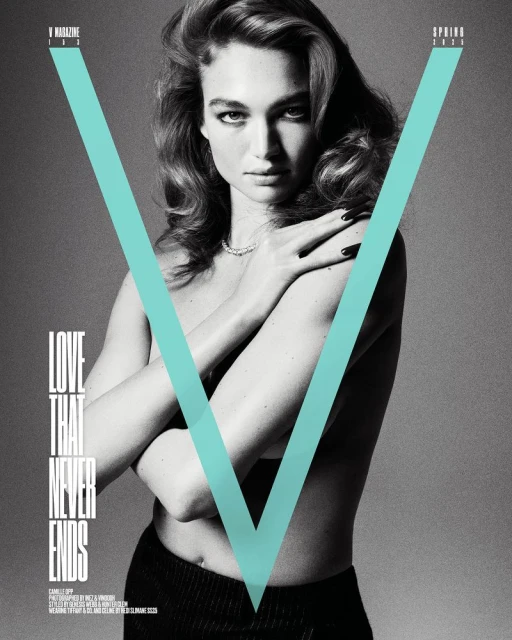 V Magazine cover featuring a fair-skinned woman with wavy brown hair, wearing a necklace, black bottoms, and teal V graphic overlay.
