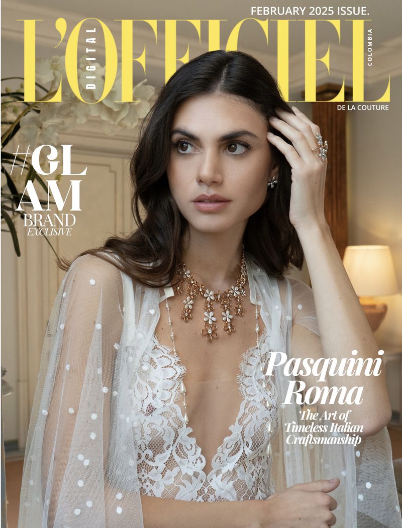 Fashion magazine cover featuring a woman in a lace dress and sheer robe, adorned with jewelry, set against a neutral background indoors.
