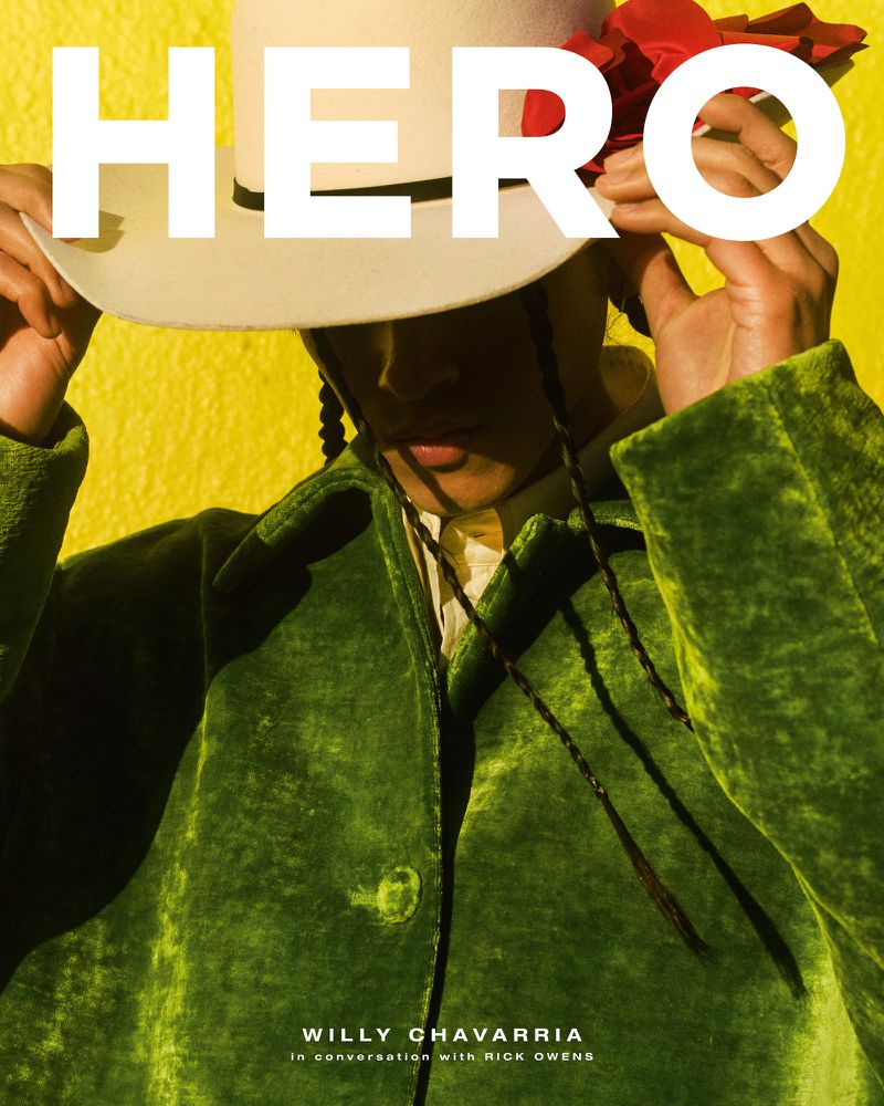 Magazine cover featuring a person in a green velvet coat and a cream hat, set against a yellow background with the word 'HERO' in large white letters.