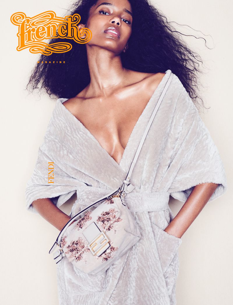 French Magazine cover featuring a Black female model in a plush robe with a Fendi handbag, captured in a medium shot with bright lighting.