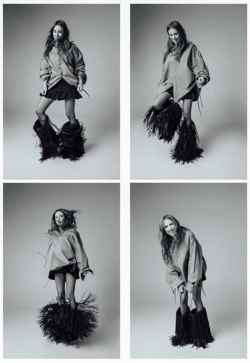 Four-panel black and white portrait of actress Emma Roberts posing in an oversized shirt and fringed boots against a neutral backdrop.