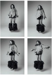 Four-panel black and white sequence of Emma Roberts jumping mid-air wearing an oversized shirt and voluminous feathered boots in a studio.