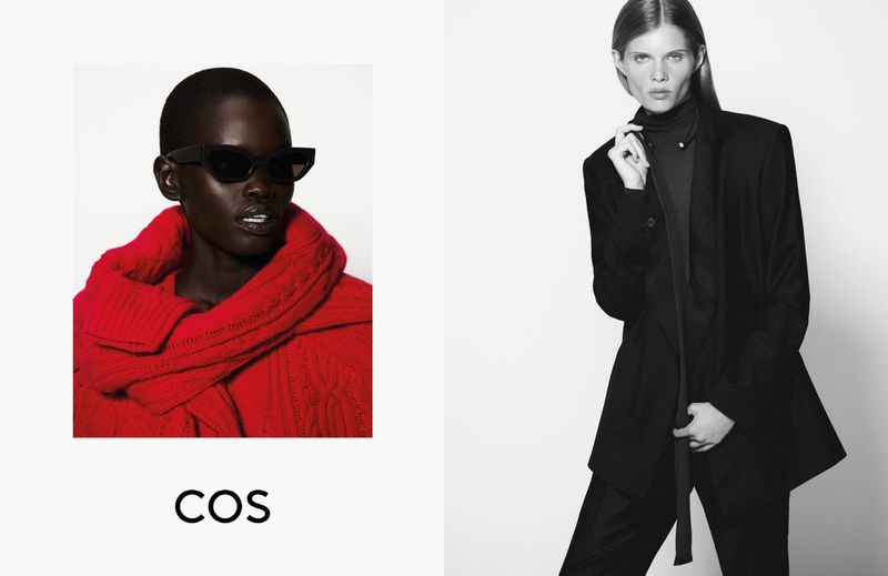 Fashion editorial featuring two adult females; one in a red sweater with sunglasses, and another in a black pant suit. Studio lit.