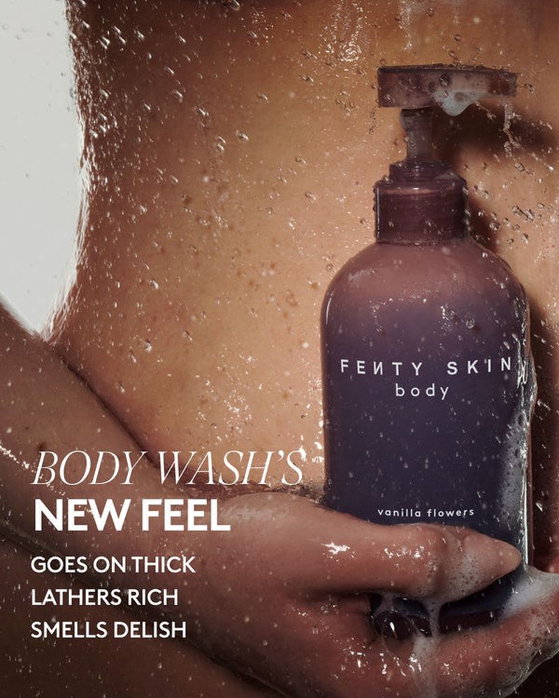 Fenty Skin body wash bottle held by an adult in a shower with running water. The image highlights the product's texture and moisturizing effect.
