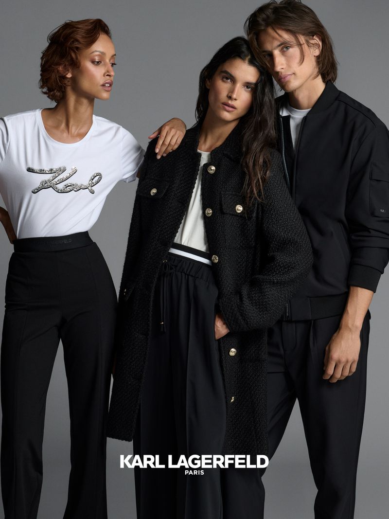 Fashion campaign shot featuring two women and one man showcasing Karl Lagerfeld apparel in a studio setting, medium full shot, grey background.