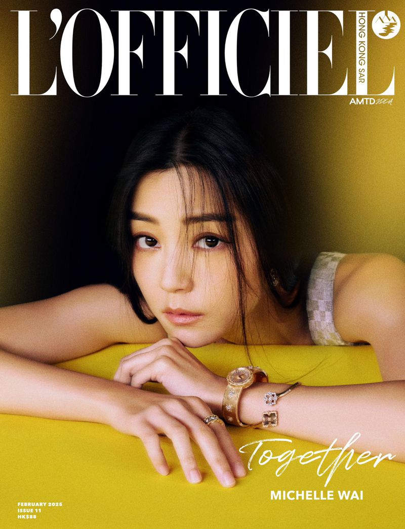 Close-up cover portrait of Michelle Wai leaning on a yellow surface wearing jewelry for L'Officiel Hong Kong magazine