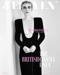 Monochrome portrait of actor Imogen Poots in a black long-sleeved dress holding a flower against a white background