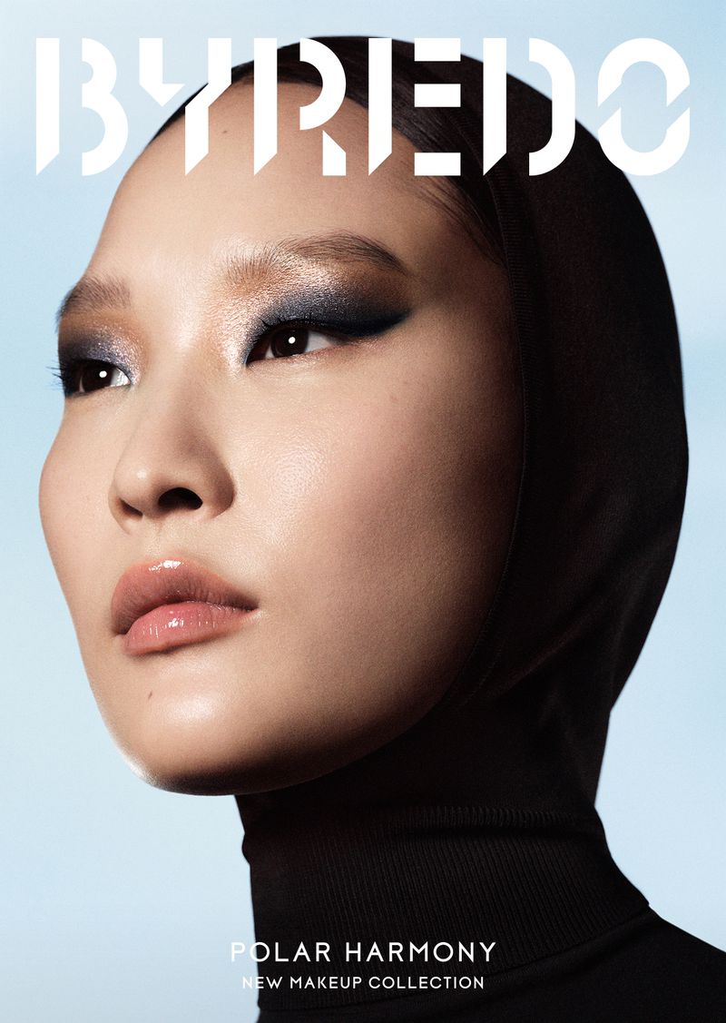 Close-up shot of a beautiful Asian woman with smokey eyeshadow and a black turtleneck, promoting Byredo's Polar Harmony makeup collection.