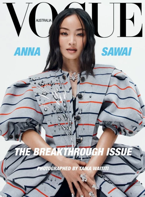 Magazine cover featuring Anna Sawai, Vogue Australia. She's wearing a striped jacket with puffed sleeves, complemented by statement rings and necklace.