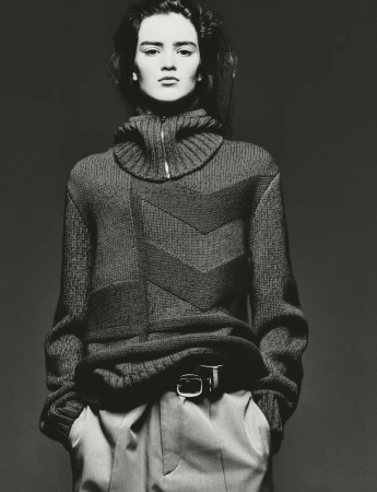 Model Niamh Battersby wearing a high-neck patterned knit sweater in a black and white editorial portrait.