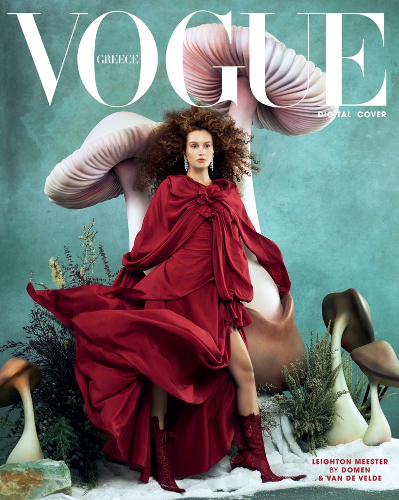 Vogue Greece digital cover featuring a woman in a red dress with mushrooms against a blue-green background. Fashion editorial.