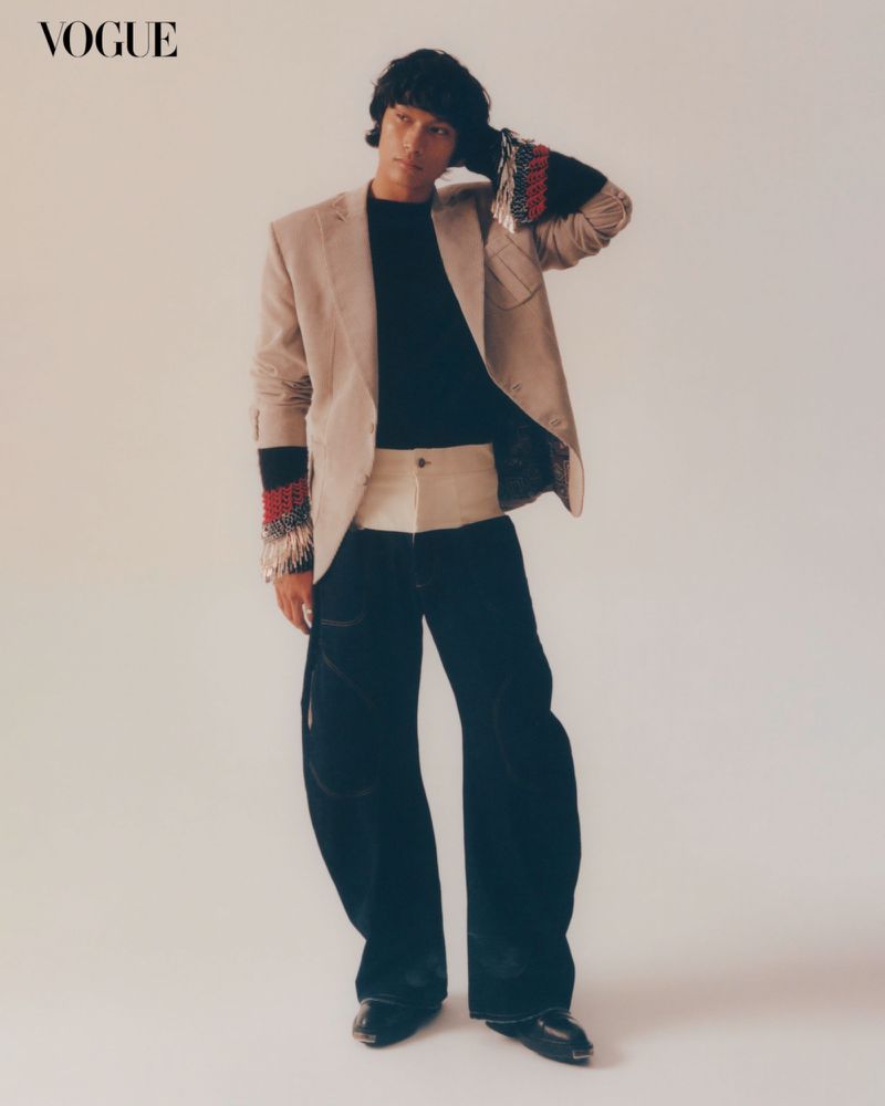 Model Isaiah Zacarias in a beige blazer and dark trousers posing for Vogue Man Philippines March 2025 Cover