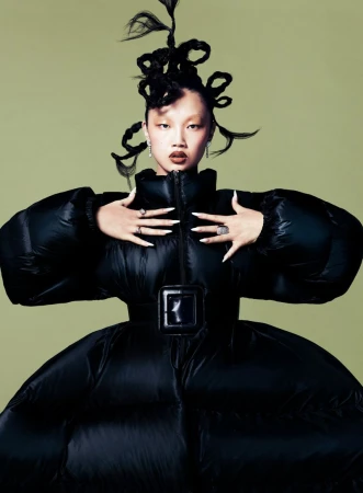 Audrey Nuna wearing an exaggerated black puffer jacket and sculptural braided hair in a Vogue Singapore editorial portrait